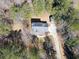 Aerial view of the home showcasing its layout, driveway, and surrounding trees at 815 Lake Stone Lea Dr, Oxford, GA 30054