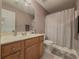 Bathroom featuring neutral walls, shower-tub combo, and vanity with wood cabinets at 815 Lake Stone Lea Dr, Oxford, GA 30054