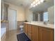 Bright bathroom with a double sink vanity, large mirror, and a separate toilet room at 815 Lake Stone Lea Dr, Oxford, GA 30054