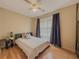 Cozy bedroom with hardwood floors, ceiling fan, and bright windows at 815 Lake Stone Lea Dr, Oxford, GA 30054