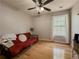 Cozy bedroom with hardwood floors, natural light, and a comfortable futon at 815 Lake Stone Lea Dr, Oxford, GA 30054