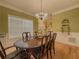 Formal dining room with a large window and hardwood floors at 815 Lake Stone Lea Dr, Oxford, GA 30054