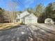 Two-story home with a long drive, large garage, and backyard storage shed at 815 Lake Stone Lea Dr, Oxford, GA 30054