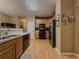 Traditional kitchen with stainless appliances and light wood cabinetry at 815 Lake Stone Lea Dr, Oxford, GA 30054