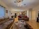Open concept living room with hardwood floors, sofas, and adjoining dining area at 815 Lake Stone Lea Dr, Oxford, GA 30054