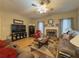 Inviting living room with a stone fireplace, hardwood floors, and a ceiling fan at 815 Lake Stone Lea Dr, Oxford, GA 30054