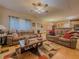 Spacious living room featuring hardwood floors, comfortable sofas, and a ceiling fan at 815 Lake Stone Lea Dr, Oxford, GA 30054