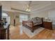 Spacious main bedroom featuring hardwood floors, decorative ceilings, fan, and an area rug at 815 Lake Stone Lea Dr, Oxford, GA 30054
