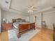 Main bedroom featuring a trey ceiling and hardwood floors at 815 Lake Stone Lea Dr, Oxford, GA 30054