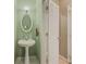 Half bath featuring modern sink and oval mirror at 815 Lake Stone Lea Dr, Oxford, GA 30054
