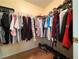 Walk-in closet featuring custom shelving and hardwood floors for optimal organization at 815 Lake Stone Lea Dr, Oxford, GA 30054