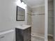 Bathroom with a tiled shower, modern vanity, mirror and commode at 819 Forrest Se Cir, Atlanta, GA 30354