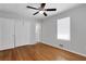 Bedroom features hardwood floors, a ceiling fan, closet and a large window at 819 Forrest Se Cir, Atlanta, GA 30354