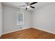 Bright bedroom with a ceiling fan, hardwood floors, and a large window at 819 Forrest Se Cir, Atlanta, GA 30354
