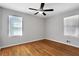 Bright bedroom with hardwood floors, ceiling fan, and windows offering natural light at 819 Forrest Se Cir, Atlanta, GA 30354