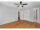 Spacious bedroom with hardwood floors, ceiling fan, and a view into the bathroom at 819 Forrest Se Cir, Atlanta, GA 30354