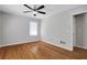 Cozy bedroom with hardwood floors, a ceiling fan, and a bright window at 819 Forrest Se Cir, Atlanta, GA 30354