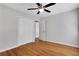Bedroom with hardwood floors, ceiling fan, and a closet with white doors at 819 Forrest Se Cir, Atlanta, GA 30354