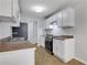 Bright kitchen featuring white cabinets, stainless steel appliances, tile flooring, and ample cabinet space at 819 Forrest Se Cir, Atlanta, GA 30354