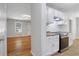 Bright kitchen featuring white cabinets, stainless steel appliances, and views to the living room at 819 Forrest Se Cir, Atlanta, GA 30354