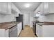Bright kitchen featuring white cabinets, stainless steel appliances, tile flooring, and ample cabinet space at 819 Forrest Se Cir, Atlanta, GA 30354