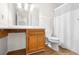 A cozy bathroom with a single sink vanity, vinyl floors, and a shower with curtain at 1205 Gettysburg Pl, Sandy Springs, GA 30350