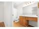 Bathroom features a vanity, toilet, mirror, and shower with new tile at 1205 Gettysburg Pl, Sandy Springs, GA 30350