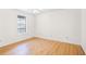 Bright bedroom featuring hardwood floors, a window, and neutral wall color at 1205 Gettysburg Pl, Sandy Springs, GA 30350