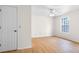 Bright bedroom with wood-look flooring, ceiling fan, and a large window at 1205 Gettysburg Pl, Sandy Springs, GA 30350