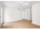 Bright bedroom with wood-look flooring, ceiling fan, and door to the outside at 1205 Gettysburg Pl, Sandy Springs, GA 30350