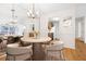 Elegant dining room with stylish lighting fixture and view to the kitchen at 1205 Gettysburg Pl, Sandy Springs, GA 30350