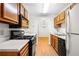 Cozy kitchen featuring wood cabinets, black appliances, and durable countertops at 1205 Gettysburg Pl, Sandy Springs, GA 30350