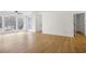 Bright living room with large windows, ceiling fan, and stylish hardwood flooring at 1205 Gettysburg Pl, Sandy Springs, GA 30350