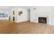 Open-concept living area with hardwood floors and cozy fireplace at 1205 Gettysburg Pl, Sandy Springs, GA 30350