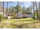 Expansive backyard with lush green grass, mature trees, and a wooden fence offering privacy at 2190 Spalding Dr, Sandy Springs, GA 30350