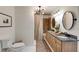 Bathroom with dual sinks, bathtub with shower, and modern fixtures at 2190 Spalding Dr, Sandy Springs, GA 30350