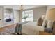 Inviting bedroom with a cozy window seat, plush bedding, and hardwood floors at 2190 Spalding Dr, Sandy Springs, GA 30350