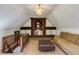 Bonus room features wood beams, a high ceiling, hardwood floors, and comfortable seating at 2190 Spalding Dr, Sandy Springs, GA 30350