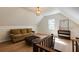 Bonus room on the upper level with a vaulted ceiling, hardwood flooring, and comfortable seating at 2190 Spalding Dr, Sandy Springs, GA 30350