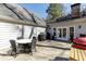 Open wooden deck featuring an outdoor dining set and a grilling area for outdoor gatherings at 2190 Spalding Dr, Sandy Springs, GA 30350