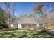 Charming home exterior featuring a covered porch and well-manicured lawn at 2190 Spalding Dr, Sandy Springs, GA 30350