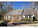 Charming exterior view of a home with a welcoming front porch and landscaped yard at 2190 Spalding Dr, Sandy Springs, GA 30350
