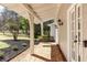 Inviting front porch with a swing, brick flooring, and charming details at 2190 Spalding Dr, Sandy Springs, GA 30350