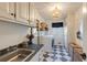 Well-appointed laundry room features a sink, cabinetry, washer, dryer, and a large window at 2190 Spalding Dr, Sandy Springs, GA 30350