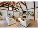 Spacious living room featuring a vaulted ceiling with wood beams and stylish furniture at 2190 Spalding Dr, Sandy Springs, GA 30350