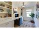 Bright office featuring custom built-in bookshelves and cabinets, a desk and stylish contemporary lighting at 2190 Spalding Dr, Sandy Springs, GA 30350