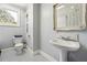 Clean bathroom featuring decorative tiling, a window for natural light, and a pedestal sink at 4828 Lakewood Dr, Acworth, GA 30101
