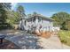 Charming two-story home with gray siding, blue shutters, and a spacious front yard with a long driveway at 4828 Lakewood Dr, Acworth, GA 30101