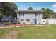 View of a two story home, showing the yard, blue shutters, and a matching shed to the side of the house at 4828 Lakewood Dr, Acworth, GA 30101