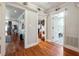 Hallway displaying multiple doorways to adjacent rooms including the living area, pantry, and bathroom at 4828 Lakewood Dr, Acworth, GA 30101